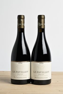 two bottles of wine sitting on top of a table next to each other