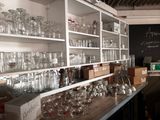 many glasses on the shelves in the room