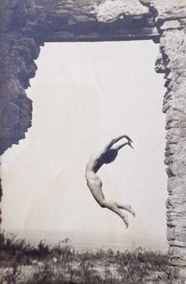 an old black and white photo of a person jumping in the air
