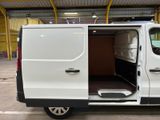 a white van with its doors open in a warehouse