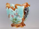 a vase that is sitting on a stand on a table