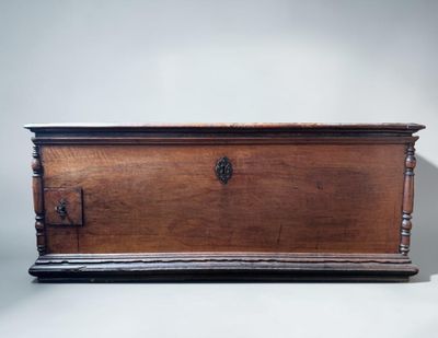 an old wooden chest sitting on top of a white surface