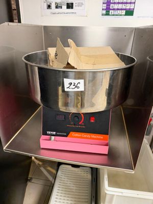 a large metal bowl with a box on top of it