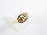 a close up of a gold ring with a diamond on it