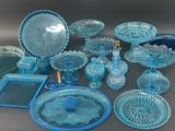 a lot of blue glass dishes and dishes on the table
