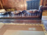a statue of a man laying down on a bench