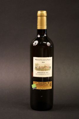 a bottle of wine sitting on top of a table next to a bottle of wine