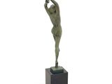 statue of a man holding a tennis racquet on top of a wooden base