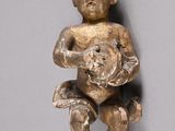 a small statue of a baby holding a teddy bear