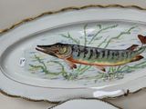 a plate with a fish painted on it and a plate with a fish painted on it