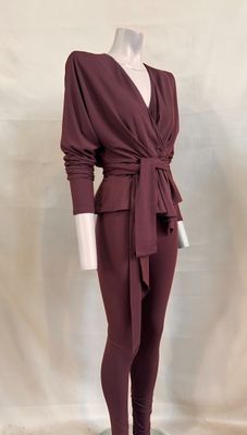 the mannequin is wearing a burgundy colored outfit with a belt