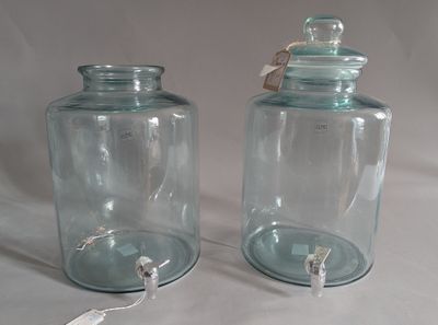 two glass jars that are sitting on a table