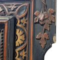 a black and brown cabinet with a mirror on top of it