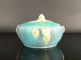 a blue bowl with yellow flowers on it sitting on a table