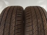 two tires are shown side by side on a white surface