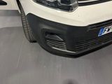 the front end of a white van parked in a garage
