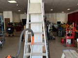 a picture of a room with a ladder and a vacuum in it