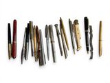 many different types of pens lined up on a white surface