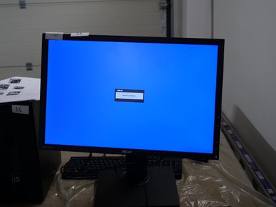 a computer monitor with a blue screen sitting on a desk