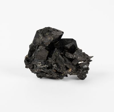 a close up of a piece of black coal on a white surface