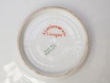 a white plate with a red inscription on it