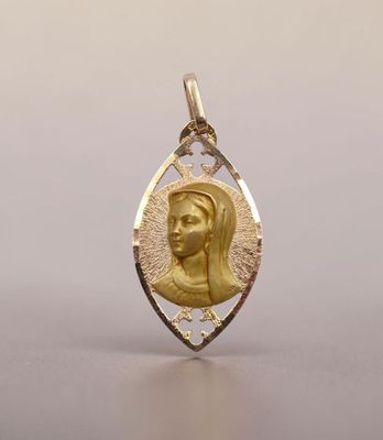 an image of a gold pendant with a woman ' s face in the center
