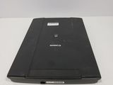 a black laptop sitting on a white table