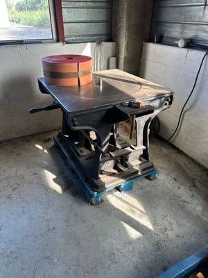 a small table with a bucket on it in a room