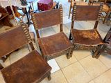 several chairs are lined up in a room with a table in the background