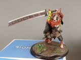 statue of a cat with a sword on top of a box
