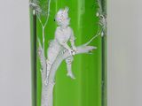 a green glass vase with a picture of a boy on a tree
