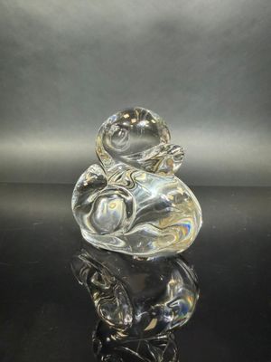 an image of a glass figurine sitting on top of a black table