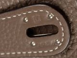 a close up of a brown leather bag with a hole in it