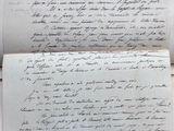 an old document with writing on it sitting on top of a table