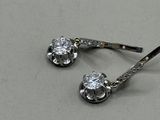 a pair of earrings that are on a table