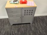 a small cabinet with a telephone on top of it
