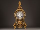 a gold clock with roman numerals on the face