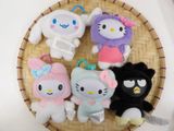 several hello kitty plush toys are arranged in a basket on a table