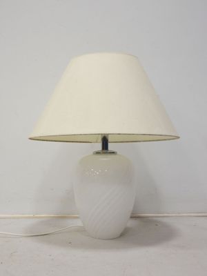 a white lamp that is sitting on a table