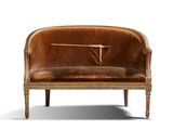 a brown velvet couch with a clock on it