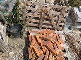 a pile of bricks sitting on the ground next to a fence