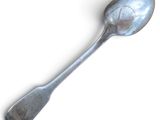 a spoon that is sitting on a white surface