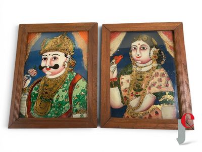 two framed paintings of a man and a woman with mustaches