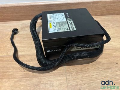 a close up of a black power supply box on a wooden surface