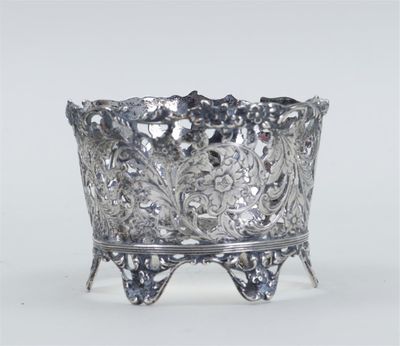 an ornate silver bowl with a flower design on a stand