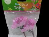 a bag of pink flowers on a black background