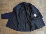 jacket on the floor with a tag on the back of the jacket