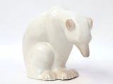 white ceramic bear figurine sitting on a white surface