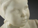 a close up of a statue of a child wearing a head scarf