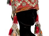 a red hat with tassels and beads on it